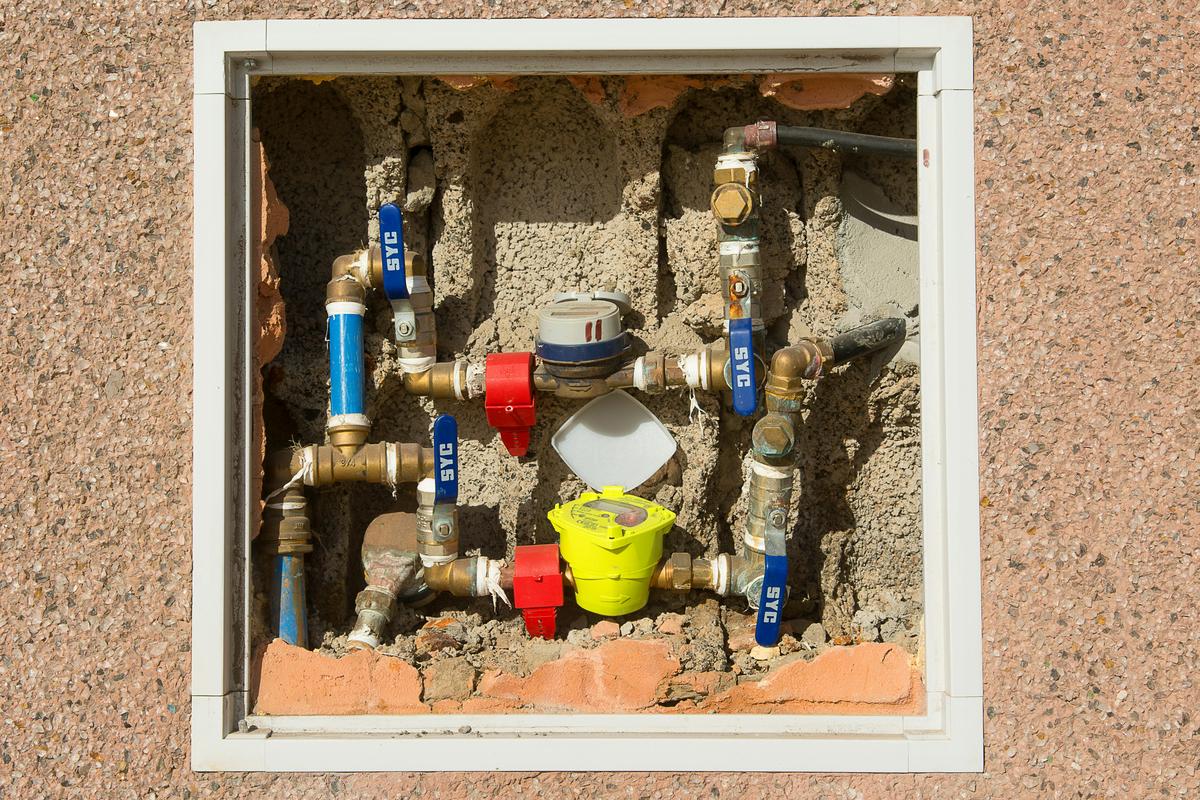 Water meter and shutoff valves inside a wall box (sample photo)