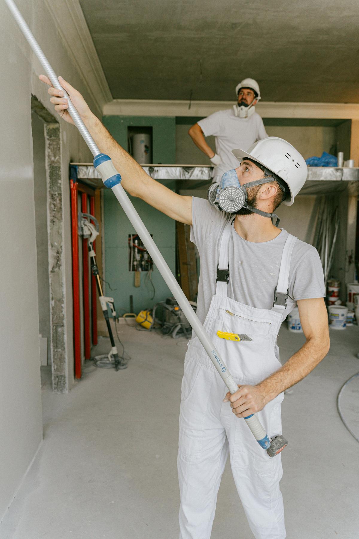 Worker in a respirator working on a ceiling (sample photo)